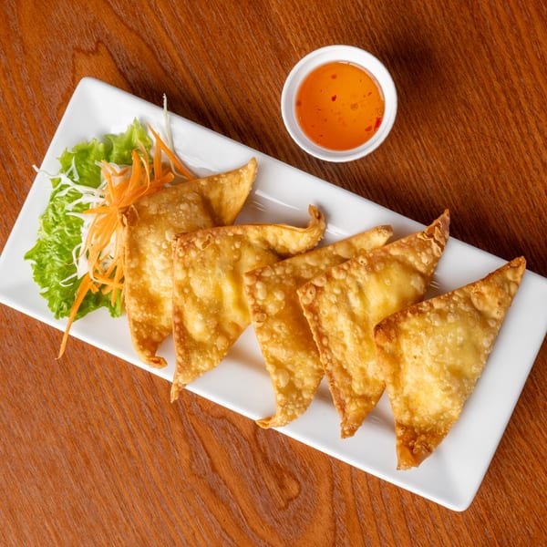 Crispy golden Thai fried wontons with shredded lettuce, carrots, and sweet chili dipping sauce.